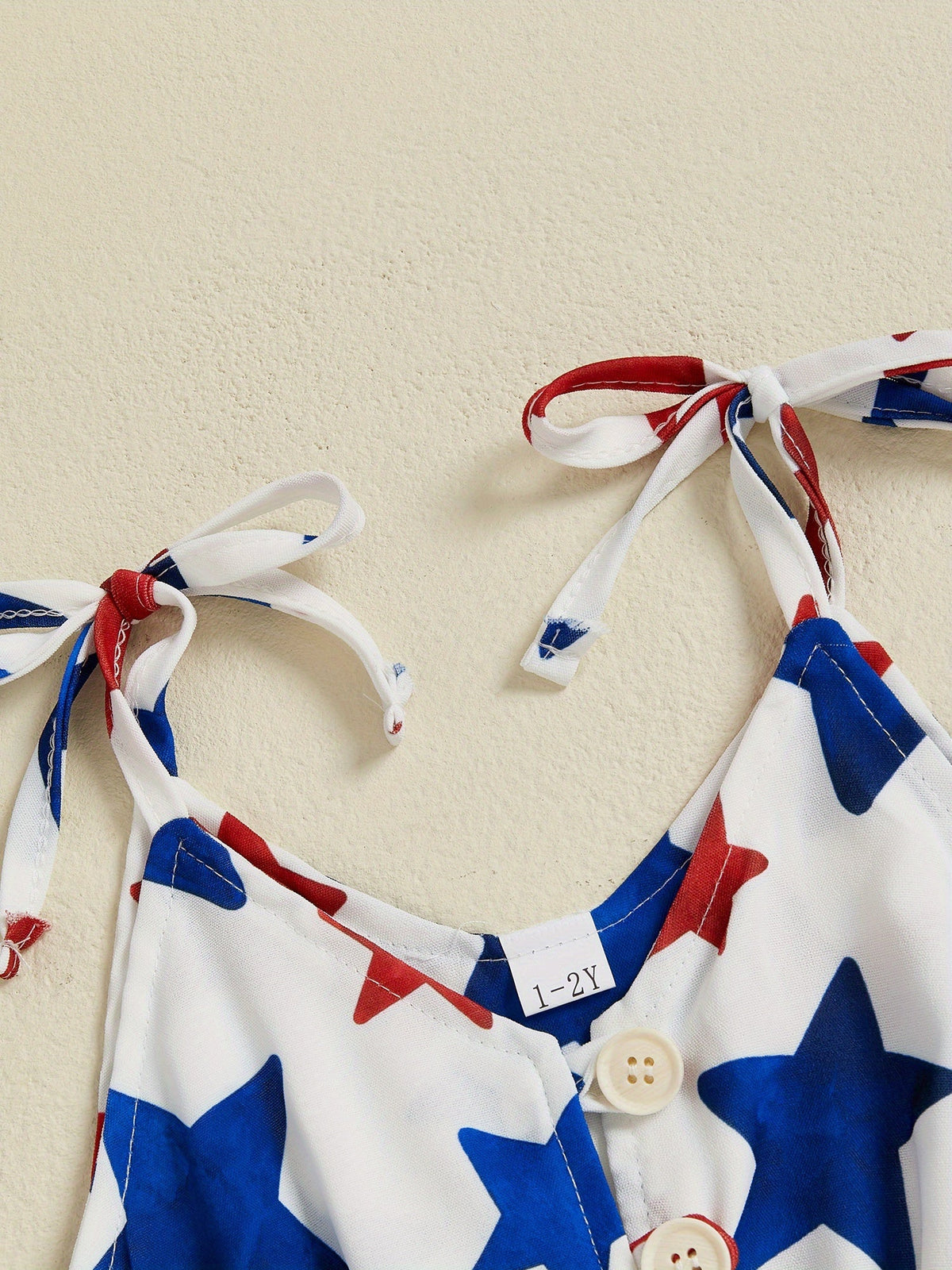 Patriotic Girls’ Sleeveless 4th of July Romper – Red White & Blue Star Print Jumpsuit with Ruffle Hem & Tie Straps